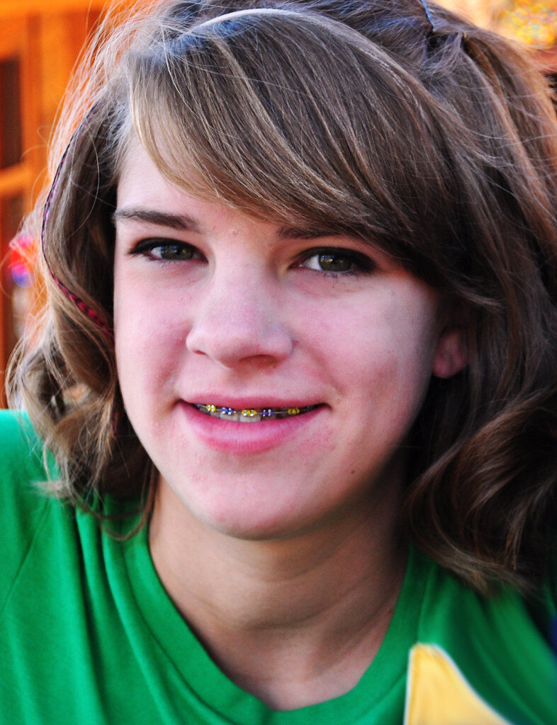 Young girl smiling in classroom cloakroom