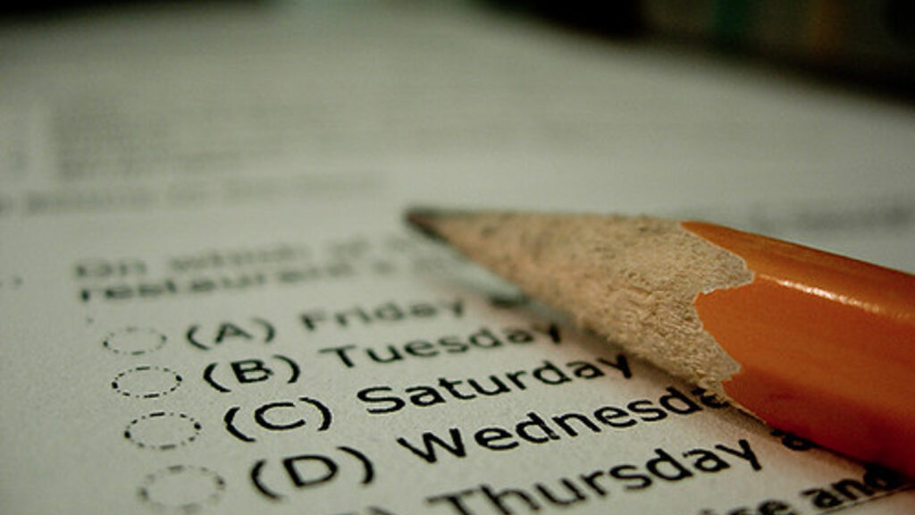 Printed exam paper on a desk with two pencils beside it