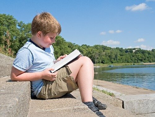 Two boys reading magazine in dormitory
