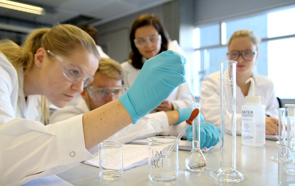 Students conducting chemistry laboratory experiment